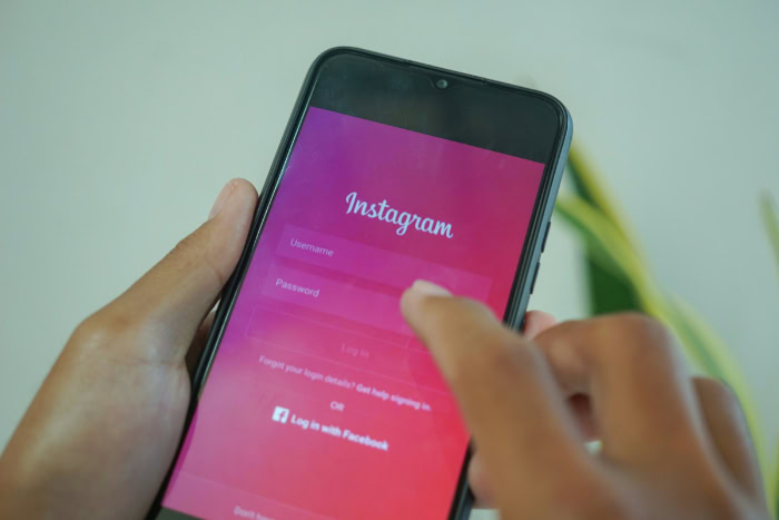 Person entering Instagram password on mobile phone