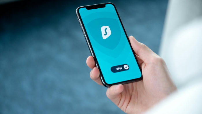 Person holding mobile phone using VPN app