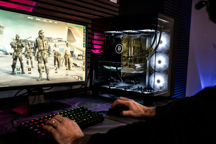 Gamer playing on high refresh monitor with RGB PC