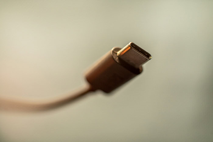 Single USB C cable close up with blurred background